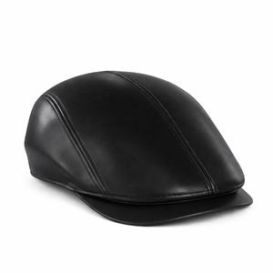 May include: A black leather newsboy cap with a curved brim. The cap has a rounded crown with two vertical seams running from front to back. The hat is made of a smooth, shiny material.