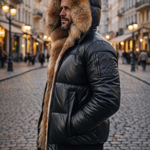 May include: Black puffer jacket with a fur-lined hood. The jacket has a glossy finish, a zippered chest pocket, and a ribbed hem. The fur trim is a light brown color. The jacket is worn with black pants.
