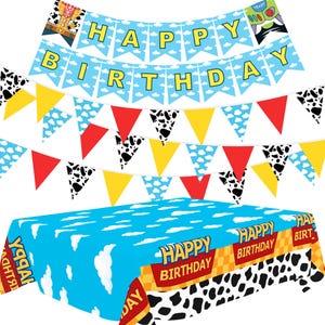 May include: A party decoration set featuring a blue and white cloud-patterned tablecloth with cow print borders and 'HAPPY BIRTHDAY' text, accompanied by two pennant banners. One banner displays 'HAPPY BIRTHDAY' in yellow letters on blue flags.
