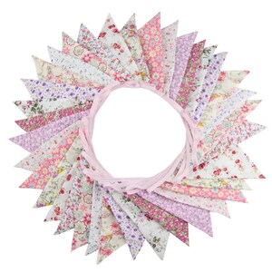 May include: A circular arrangement of triangular fabric pennants attached to a light pink ribbon. Each pennant features a unique floral pattern in shades of pink, purple, green, and white, creating a diverse collection of botanical prints.