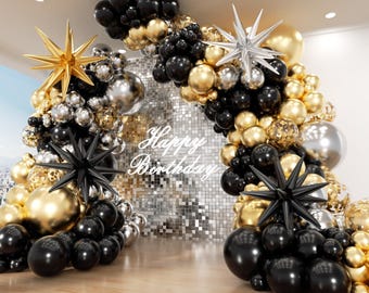 May include: A balloon arch featuring black, gold, and silver balloons with gold and black starburst accents. A silver sequin backdrop is centered behind the arch with the white text Happy Birthday displayed in the middle of the shimmering wall.