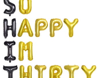 Globos divertidos para el 30 cumpleaños de él, en negro y dorado, con la frase "¡Qué feliz estoy de tener treinta!". Decoraciones para fiestas de hombres.