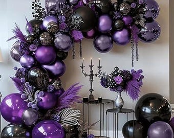 May include: A decorative arrangement featuring black and purple balloons, flowers, and decorative elements. The display includes a candelabra, small tables, and a vase with flowers. The color scheme is primarily black and shades of purple.