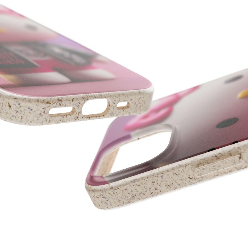 May include: Two phone cases with a pink and white design. The cases have a speckled, off-white border and cutouts for the camera and charging port. The design on the case is slightly blurred, but appears to be a cartoon character.