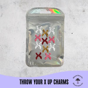 May include: A clear, holographic bag containing multiple X-shaped charms in white, gold, pink, and red. The text "THROW YOUR X UP CHARMS" is at the bottom of the image.