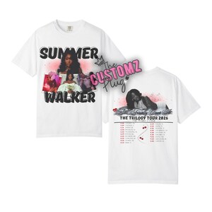 May include: White t-shirt featuring a graphic design with the text "SUMMER WALKER" and images of the artist. The back of the shirt displays tour dates and the text "THE TRILOGY TOUR 2026".