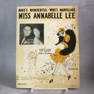 May include: Vintage sheet music cover for "Miss Annabelle Lee." The cover features illustrations of a woman in a yellow dress and a cupid with a bow and arrow. The title and featured artists are displayed prominently.