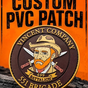 May include: A circular PVC patch featuring a cartoon illustration of a bearded person in a hat with two crossed swords behind them. The text reads VINCENT COMPANY, 699 BATTALION, and 551 BRIGADE. The patch has a brown background with gold trim.