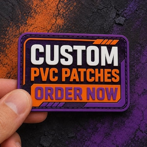 May include: A rectangular PVC patch with a purple border and dark background. The text CUSTOM is in white, PVC PATCHES is in orange, and ORDER NOW is in purple on an orange background. The design features orange geometric accents and a stitched edge.