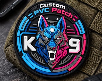 May include: A circular black PVC patch featuring a stylized wolf head in blue and pink. The text Custom PVC Patch is at the top, with the letter K on the left and the number 9 on the right. The design includes geometric lines and a snarling expression.