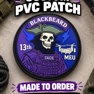 May include: A circular PVC patch featuring a skull with a beard wearing a green tricorn hat. The design includes the text BLACKBEARD, 13th, MEU, and TACE, along with a graphic of a helicopter and blue lightning bolts against a purple background.