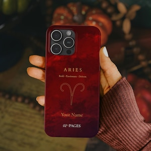 May include: A red phone case with the Aries zodiac sign, featuring the text "ARIES" and "Bold · Passionate · Driven." The case also includes space for a name and the text "12 PAGES."