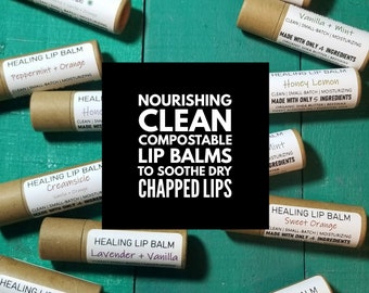 May include: Assortment of brown cardboard tubes with labels for various flavored lip balms. The labels read "Healing Lip Balm" with different flavor combinations, such as "Kauai", "Peppermint + Orange", "Creamsicle", "Honey Lemon", "Vanilla + Mint", "Sweet Orange", "Lavender + Vanilla", "Bali", and "Vanilla". The text "Nourishing Clean Compostable Lip Balms to Soothe Dry Chapped Lips" is superimposed on the image.
