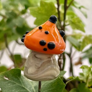 Lampwork glass mushroom toadstool with orange cap and black dots by Glass Art Revealed