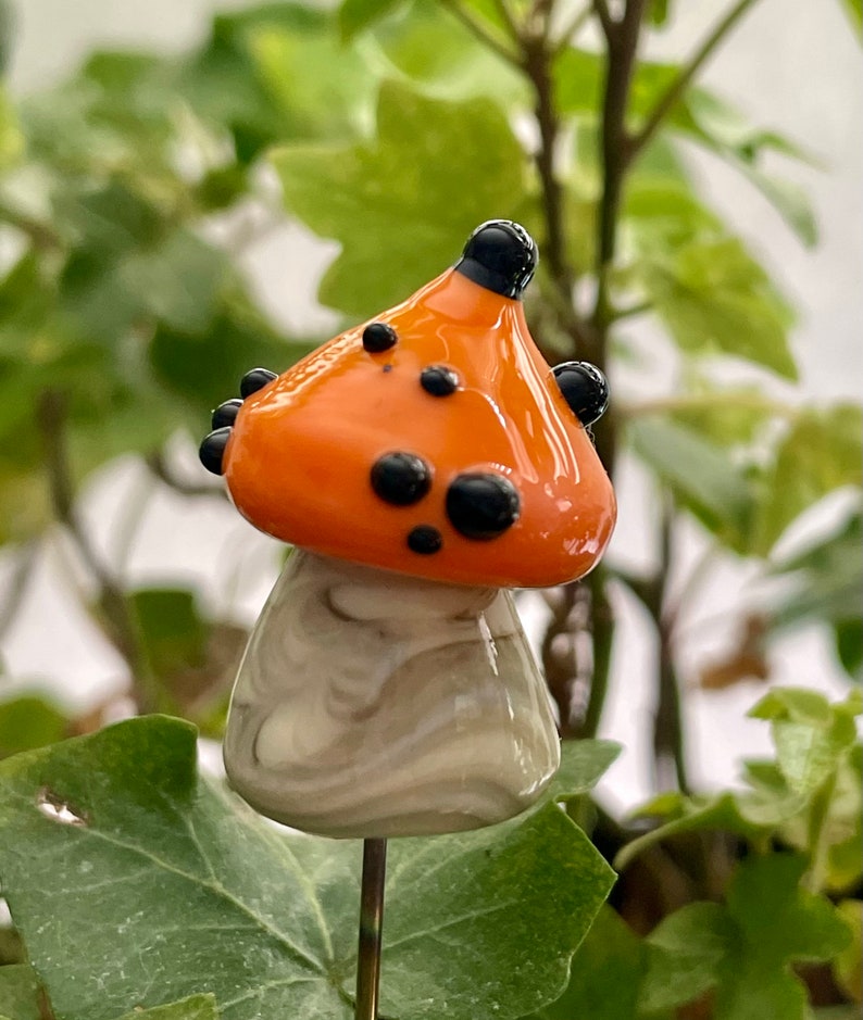 Lampwork glass mushroom toadstool with orange cap and black dots by Glass Art Revealed