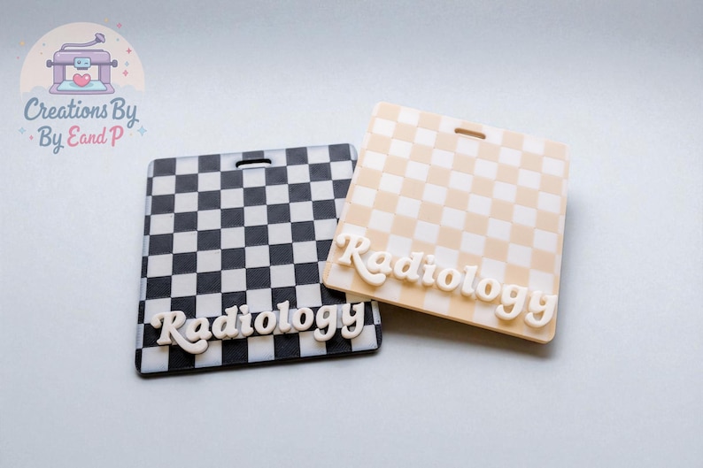 May include: Two rectangular name badges with a checkered pattern. One is black and white, the other is tan and white. The word "Radiology" is written in white, cursive letters on each badge.
