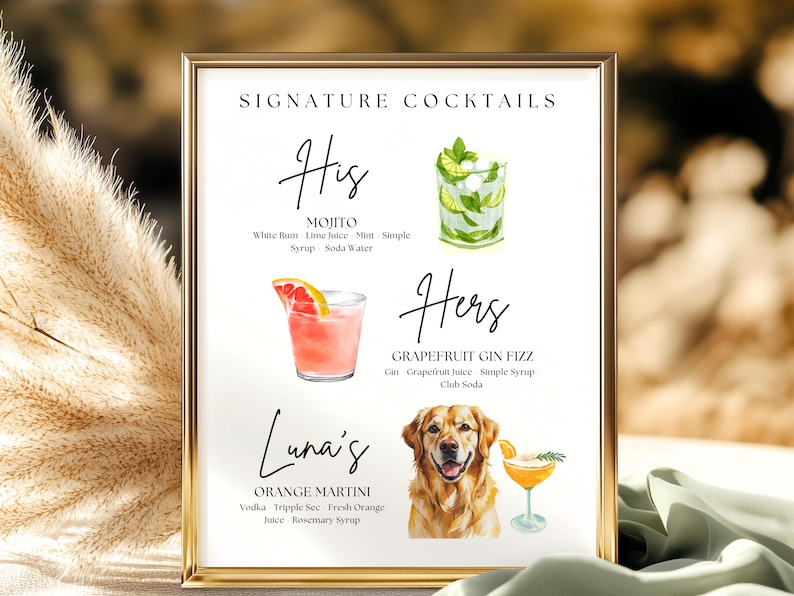 May include: A framed print with a gold border displays a cocktail menu. The menu features watercolor illustrations of cocktails: a Mojito, a Grapefruit Gin Fizz, and an Orange Martini. The text reads "Signature Cocktails".