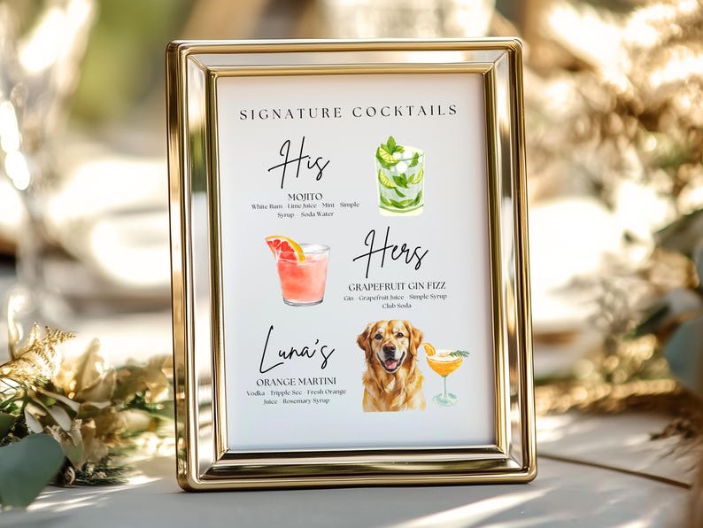 May include: A framed sign with gold trim displays a list of signature cocktails. The sign includes watercolor illustrations of a Mojito, a Grapefruit Gin Fizz, and an Orange Martini. The sign is labeled "Signature Cocktails" at the top.