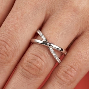 Add a touch of modern elegance with this criss cross adjustable ring, featuring pave lab grown diamonds set in a stunning X crossover design. Crafted in luxurious 14K white gold, this open statement band offers a perfect blend of sparkle and sophistication. Lightweight and comfortable, it’s ideal for everyday wear or special occasions. A unique and timeless piece, perfect as an anniversary gift, stacking ring, or standout addition to any fine jewelry collection.