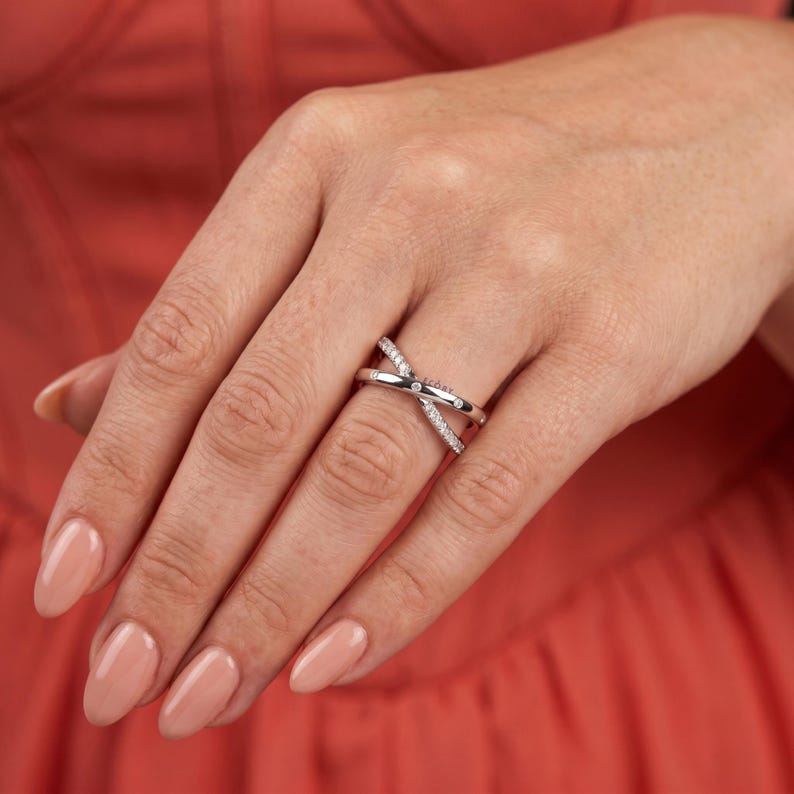 Add a touch of modern elegance with this criss cross adjustable ring, featuring pave lab grown diamonds set in a stunning X crossover design. Crafted in luxurious 14K white gold, this open statement band offers a perfect blend of sparkle and sophistication. Lightweight and comfortable, it’s ideal for everyday wear or special occasions. A unique and timeless piece, perfect as an anniversary gift, stacking ring, or standout addition to any fine jewelry collection.