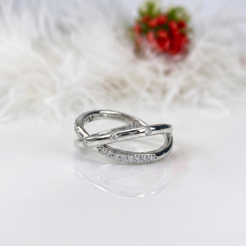 Add a touch of modern elegance with this criss cross adjustable ring, featuring pave lab grown diamonds set in a stunning X crossover design. Crafted in luxurious 14K white gold, this open statement band offers a perfect blend of sparkle and sophistication. Lightweight and comfortable, it’s ideal for everyday wear or special occasions. A unique and timeless piece, perfect as an anniversary gift, stacking ring, or standout addition to any fine jewelry collection.