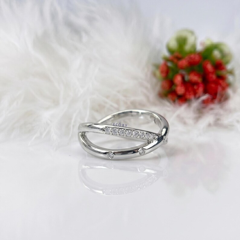 Add a touch of modern elegance with this criss cross adjustable ring, featuring pave lab grown diamonds set in a stunning X crossover design. Crafted in luxurious 14K white gold, this open statement band offers a perfect blend of sparkle and sophistication. Lightweight and comfortable, it’s ideal for everyday wear or special occasions. A unique and timeless piece, perfect as an anniversary gift, stacking ring, or standout addition to any fine jewelry collection.