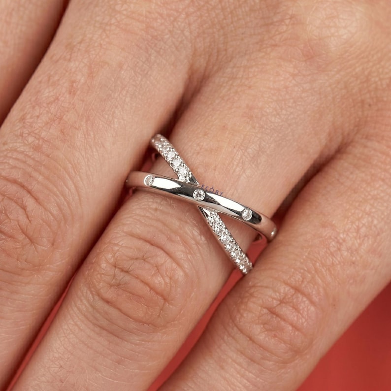 Add a touch of modern elegance with this criss cross adjustable ring, featuring pave lab grown diamonds set in a stunning X crossover design. Crafted in luxurious 14K white gold, this open statement band offers a perfect blend of sparkle and sophistication. Lightweight and comfortable, it’s ideal for everyday wear or special occasions. A unique and timeless piece, perfect as an anniversary gift, stacking ring, or standout addition to any fine jewelry collection.