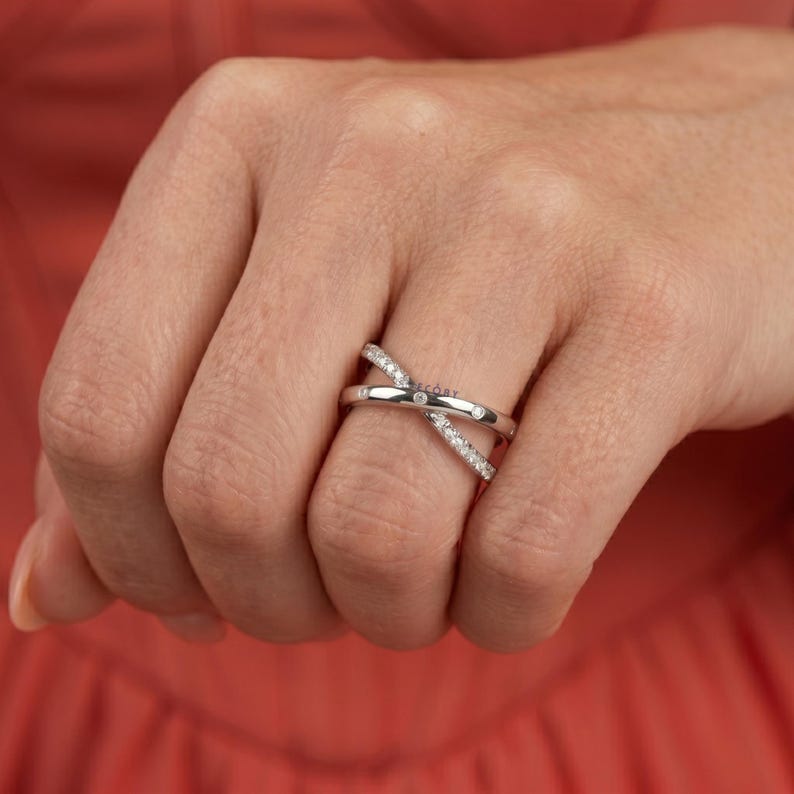 Add a touch of modern elegance with this criss cross adjustable ring, featuring pave lab grown diamonds set in a stunning X crossover design. Crafted in luxurious 14K white gold, this open statement band offers a perfect blend of sparkle and sophistication. Lightweight and comfortable, it’s ideal for everyday wear or special occasions. A unique and timeless piece, perfect as an anniversary gift, stacking ring, or standout addition to any fine jewelry collection.