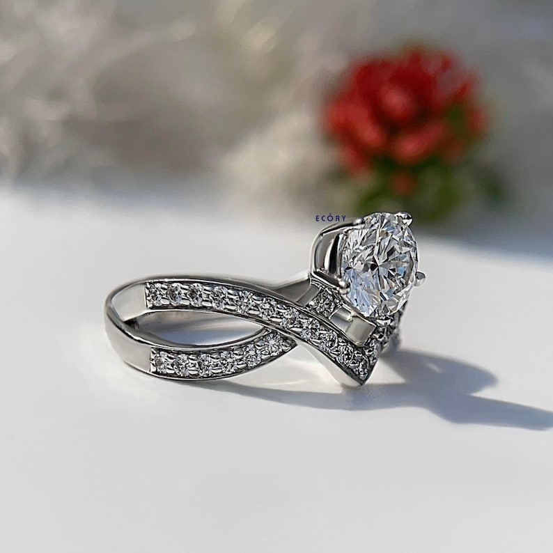 Elegant 1.10 CT round lab grown diamond engagement ring paired with a 14K gold criss cross wedding band. Featuring dazzling D-E color and VVS-VS clarity, this handcrafted sustainable ring is perfect for proposals, anniversaries, weddings, or heirloom gifts. Ethically made fine jewelry that blends modern style with timeless beauty. Ideal for eco-conscious brides seeking conflict-free diamond rings.