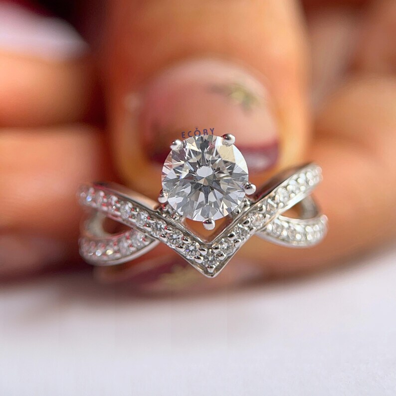 Elegant 1.10 CT round lab grown diamond engagement ring paired with a 14K gold criss cross wedding band. Featuring dazzling D-E color and VVS-VS clarity, this handcrafted sustainable ring is perfect for proposals, anniversaries, weddings, or heirloom gifts. Ethically made fine jewelry that blends modern style with timeless beauty. Ideal for eco-conscious brides seeking conflict-free diamond rings.