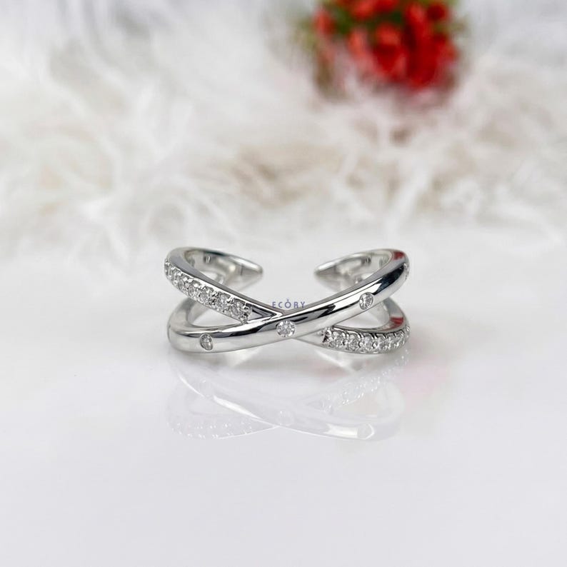 Add a touch of modern elegance with this criss cross adjustable ring, featuring pave lab grown diamonds set in a stunning X crossover design. Crafted in luxurious 14K white gold, this open statement band offers a perfect blend of sparkle and sophistication. Lightweight and comfortable, it’s ideal for everyday wear or special occasions. A unique and timeless piece, perfect as an anniversary gift, stacking ring, or standout addition to any fine jewelry collection.