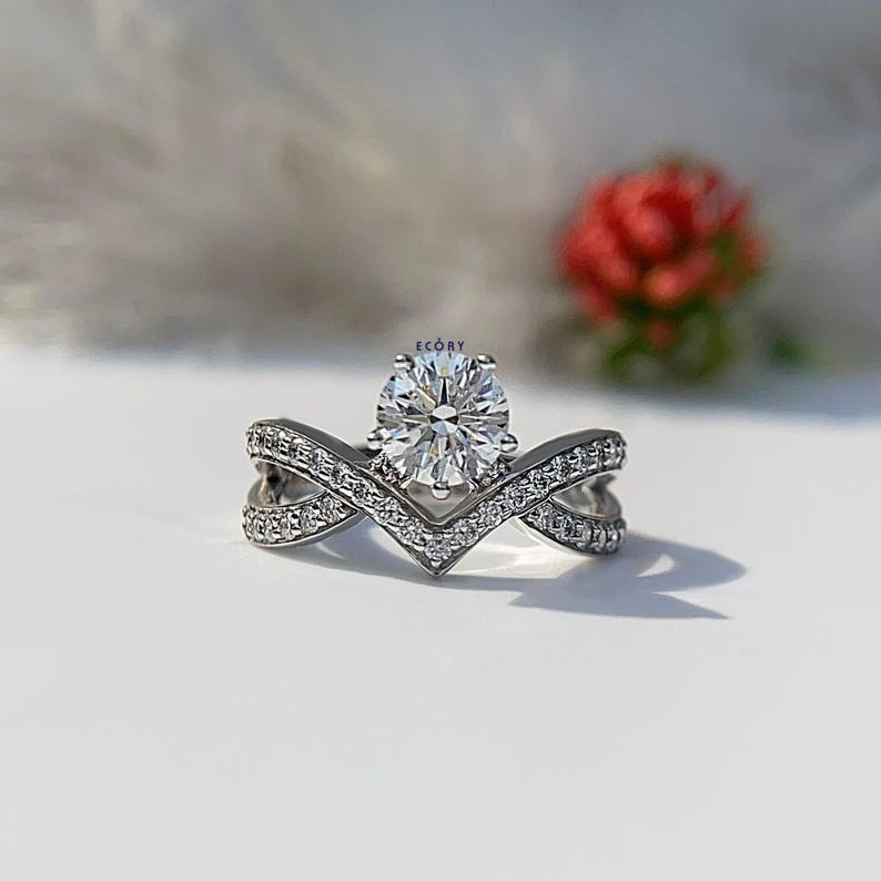 Elegant 1.10 CT round lab grown diamond engagement ring paired with a 14K gold criss cross wedding band. Featuring dazzling D-E color and VVS-VS clarity, this handcrafted sustainable ring is perfect for proposals, anniversaries, weddings, or heirloom gifts. Ethically made fine jewelry that blends modern style with timeless beauty. Ideal for eco-conscious brides seeking conflict-free diamond rings.