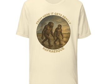 May include: Cream-colored t-shirt featuring a circular graphic with two ape-like figures walking in a landscape. The graphic includes the text "FROM HERE IT GETS REALLY" and "KAFKAESQUE" in a circular design. The shirt has short sleeves and a crew neck.