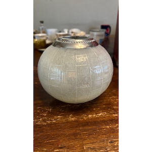 May include: A set of three ceramic mugs with a speckled, matte finish. The mugs are in shades of cream, light gray, and dark gray. Each mug has a simple, minimalist design, perfect for coffee or tea.
