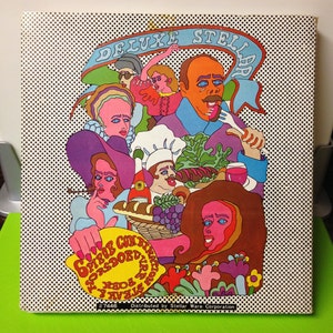 May include: A colorful illustration of a dinner plate with a variety of foods, including a steak, vegetables, and a side of bread. The plate is surrounded by a variety of people, all with unique hairstyles and clothing. The text "DELUXE STELLA" is at the top of the image.