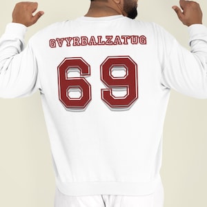 May include: White long-sleeve sweatshirt with the number "69" in maroon and white, and the text "GVYRBALZATUG" above the number. The sweatshirt is a casual style.