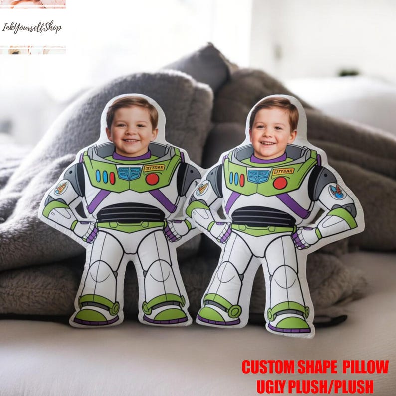 Two custom-shaped pillows with images of smiling children on them, placed on a bed.