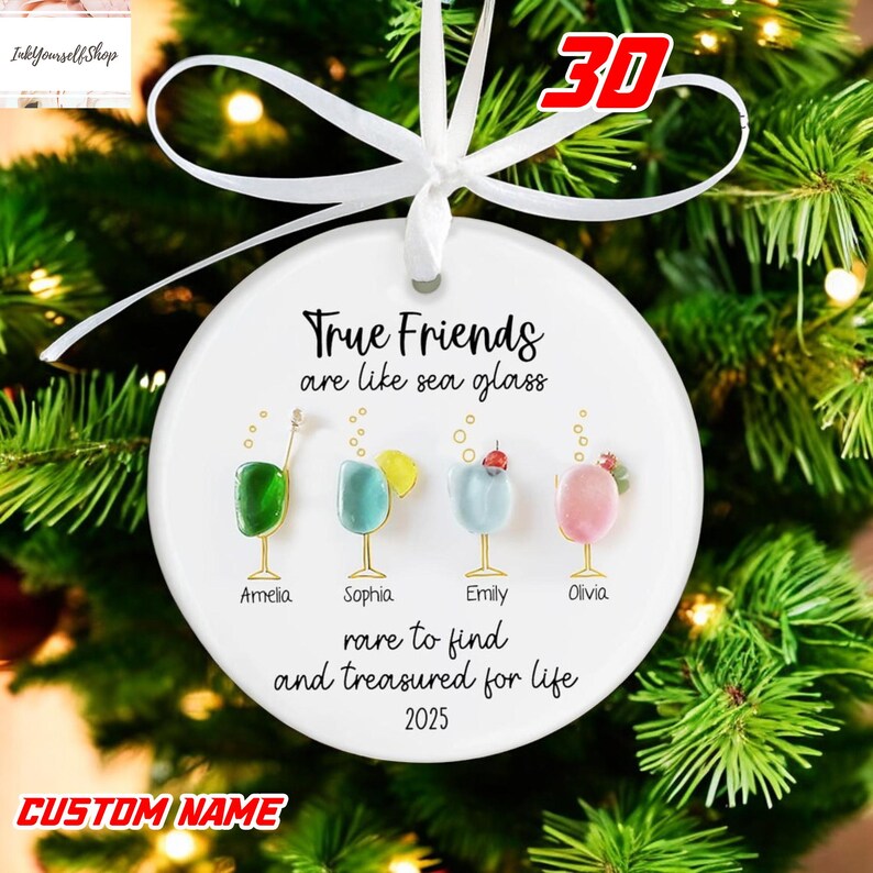 A white ornament with a ribbon, featuring illustrations of four different colored drinks and the text "True Friends are like sea glass" along with the names "Armelia, Sophia, Emily, Olivia" and the year "2025".