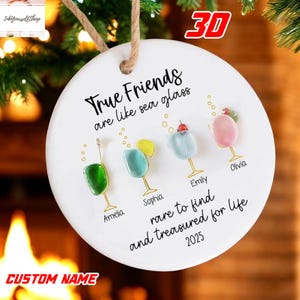 A white ornament with a message about true friends, and four different colored glass ornaments with names on them.