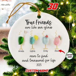 A white ornament with a message about true friends, featuring four different colored sea glass ornaments and a red arrow pointing to the one that says "Olivia".