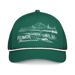May include: A dark green baseball cap featuring a white rope detail across the base of the crown. The front displays a white line art graphic of a mountain landscape with a lake and trees, accompanied by the text Rumor Tennessee in white.