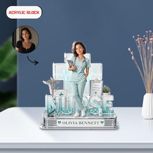 May include: An acrylic block featuring a nurse in light blue scrubs, a stethoscope, and a medical chart. The block spells out "NURSE" with a cross and heartbeat design in the background. The name "Olivia Bennett" is displayed at the base.