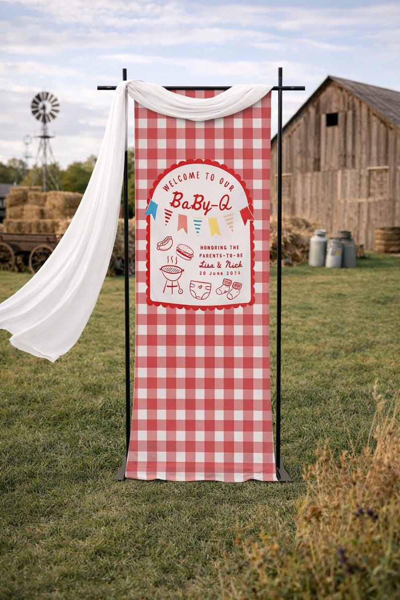 May include: A red and white chequered Baby-Q banner with the text "WELCOME TO OUR BaBy-Q" and "HONORING THE PARENTS-TO-BE Lisa & Nick 20 June 2026". The banner is displayed outdoors with a white drape.