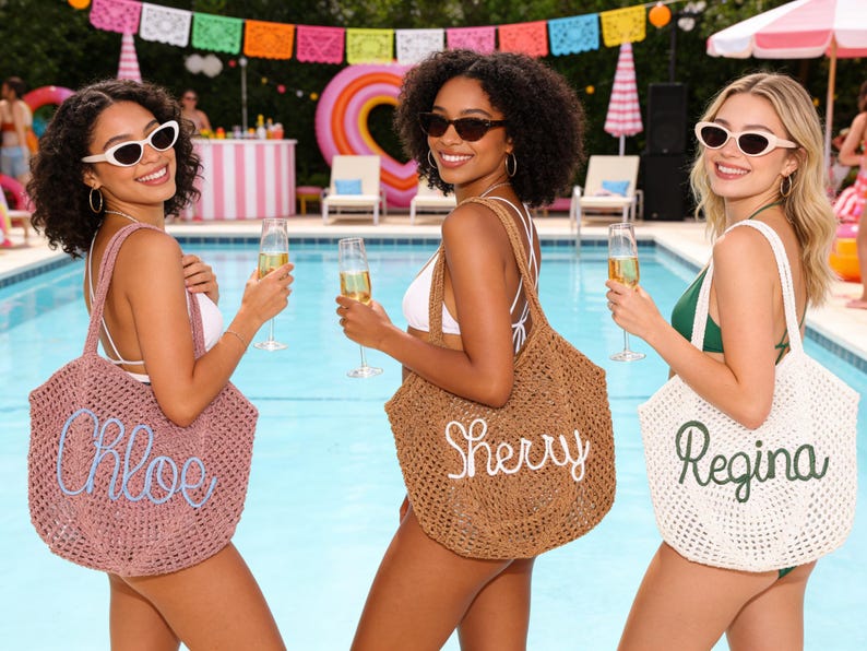 May include: Three women holding champagne flutes and wearing sunglasses pose by a pool. Each woman carries a woven tote bag with a name embroidered on it: Chloe, Sherry, and Regina. The bags are in pink, brown, and white.