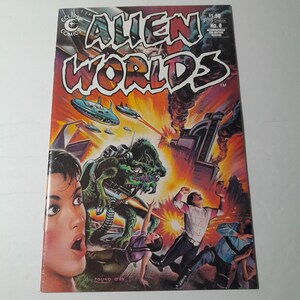 May include: A comic book cover featuring a green alien creature with three eyes and a large mouth. The alien is holding a weapon and is attacking a group of people. The cover also features a cityscape in the background and the title "Alien Worlds" in large, bold letters.