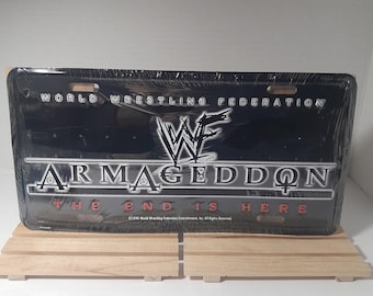 Placa de metal para fã de luta livre da WWE, Armageddon 1999, em ótimo estado de conservação.