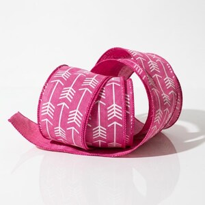 May include: A rolled-up, fuchsia-colored ribbon with a white arrow pattern. The ribbon is made of a textured material and is suitable for crafts, gift wrapping, or decorative purposes. The arrows point in one direction.