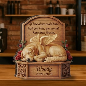 May include: Wooden pet memorial featuring a sleeping golden retriever with angel wings, surrounded by red roses. The memorial includes the text "If love alone could have kept you here, you would have lived forever." and the name "Woody" with the years 2018-2025.