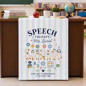 May include: A white and light blue striped table runner featuring the text SPEECH THERAPY Mrs. Laurent and EVERY WAY TO COMMUNICATE IS THE RIGHT WAY. The design includes illustrations of seven cartoon ducks, speech bubbles, books, and letters.