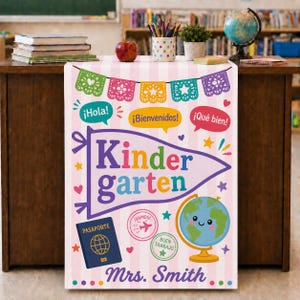 May include: A vertical banner with a light pink and white striped background featuring colorful papel picado, speech bubbles with text, a purple pennant reading Kindergarten, a blue passport, travel stamps, and a smiling globe with Mrs. Smith.